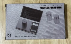Instruction manual for a digital scale with LCD display and buttons.