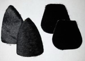 Four black felt hats of different shapes on a white background.