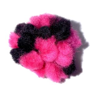 Bright pink and black fuzzy pom-poms clustered together.