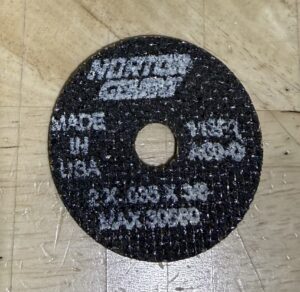 A grinding disc with product specifications printed on it.