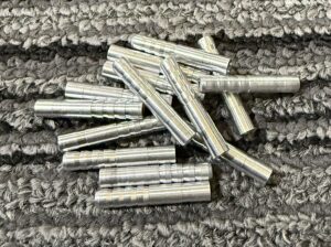 Metal wall anchors on a textured surface.