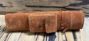 A brown suede belt with a small pouch and fringe detail.