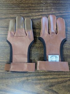 A pair of tan leather fingerless gloves with wrist straps.
