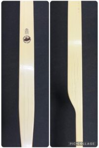 Two views of a wooden cricket bat showing front and side.
