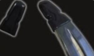 Close-up of a knife blade tip against a dark background.