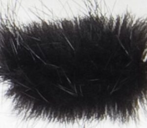 Close-up of a black fuzzy object with soft textures.