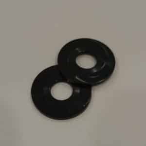 Two black rubber washers on a light surface.