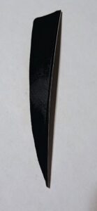 Close-up of a black knife blade with a sharp edge.
