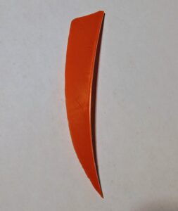 A curved orange knife blade on a white background.