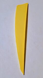 Close-up of a yellow knife blade on a white surface.