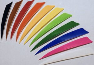 Colorful paper quilling strips arranged in a fan shape.