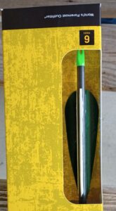 Green-tipped arrow resting in a yellow quiver holder.