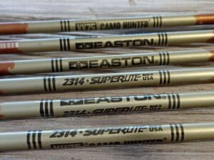 Close-up of gold Easton Superlite III baseball bats.