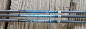 Close-up of blue fishing rods with brand and manufacturing details.