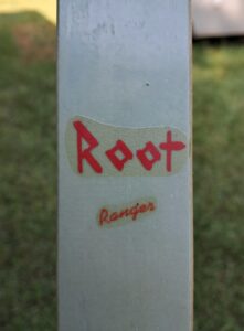 Close-up of a cricket bat with 'Root Rangers' branding.