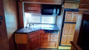 Compact kitchen area with wooden cabinets and modern appliances.