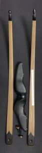 A black ergonomic handle placed between two wooden rulers.