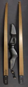 Black recurve bow mounted on a wooden display frame.