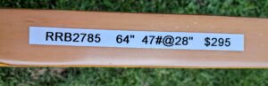 A wooden board with printed measurements and text.