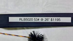 Two black rods with text labels on a white surface.