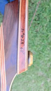 Close-up of a guitar's neck showing inlay dots and fret markings.