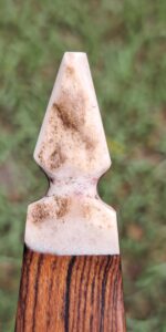 Close-up of a dirty, pointed garden tool.