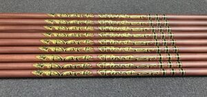 Set of decorative pencils with gold floral designs on a reddish-brown background.