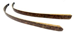 Two rusted metal blades with holes on a white background.