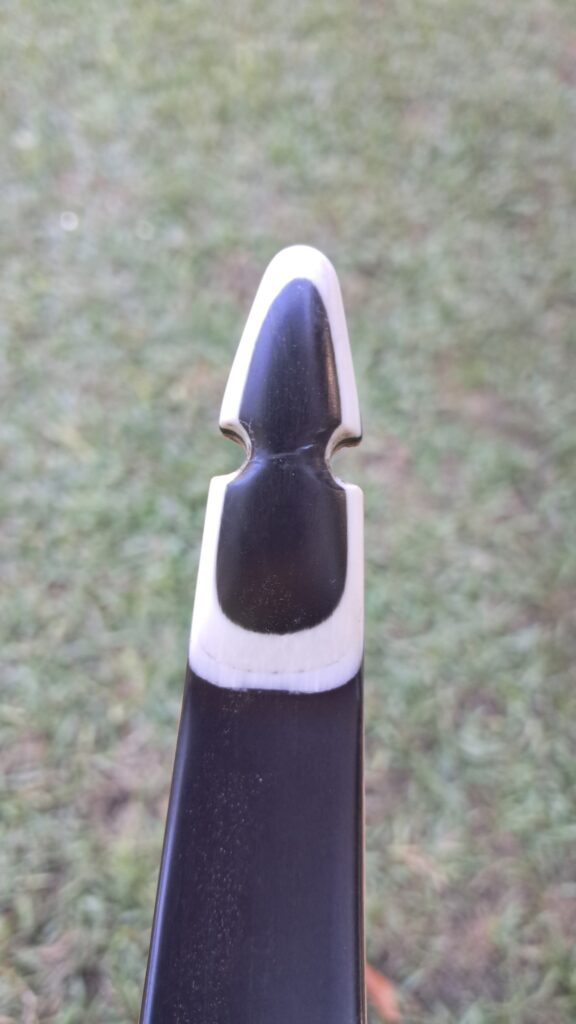 Close-up of an archery bow's arrow rest and string.