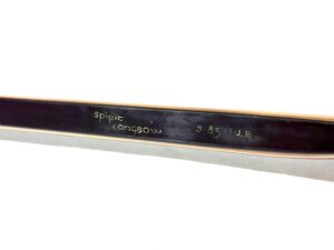Close-up of a black metal object with engraved text.