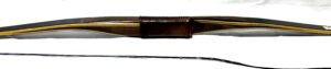 A close-up of a fishing rod with a leather grip and a rod tip.