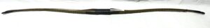 A black machete with a wrapped handle and a label on the sheath.