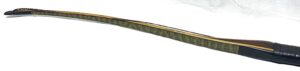 A long, wooden, intricately painted ceremonial sword or dagger.