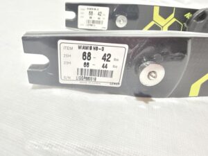 Close-up of a metal part with a label showing numbers and barcodes.