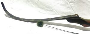 A sword with a green pom-pom attached to its sheath.