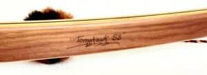 Close-up of a wooden baseball bat labeled 'Tomahawk SS'.